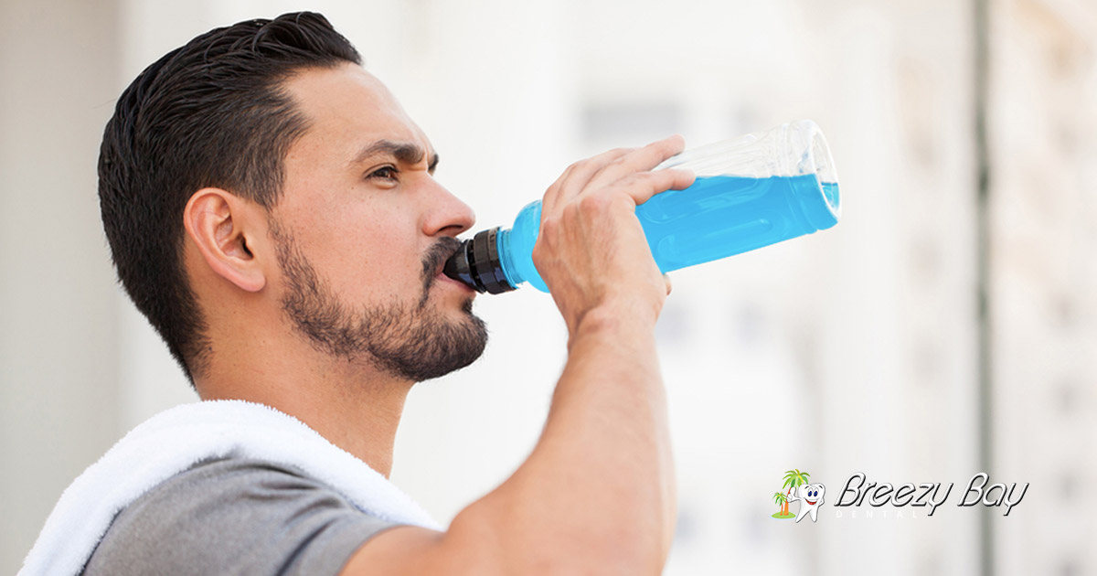 man drinking a sports drink