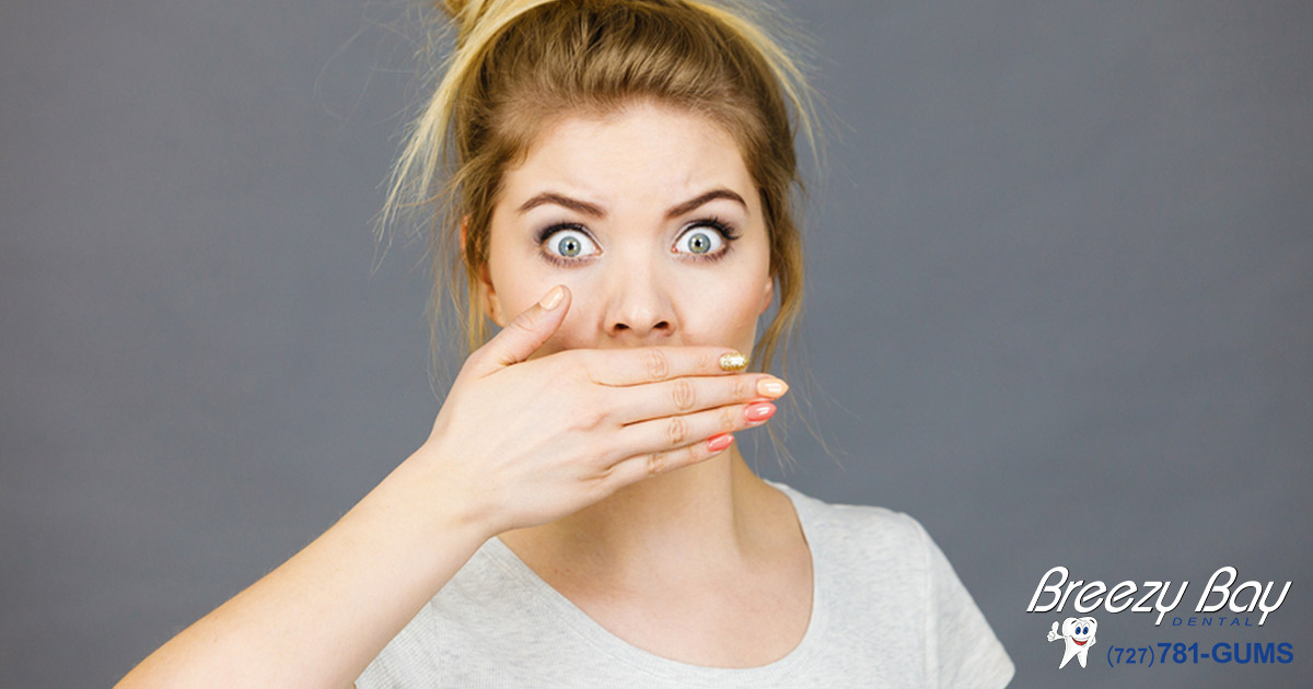 woman covering her mouth